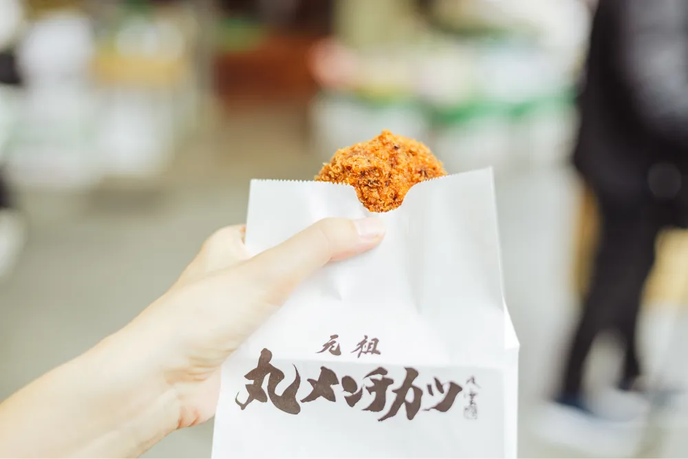 商店街には食べ歩きグルメも豊富。「吉祥寺さとう」の元祖丸メンチカツは、肉のうまみたっぷりなのに脂っぽさを感じないのでいくらでも食べられそう