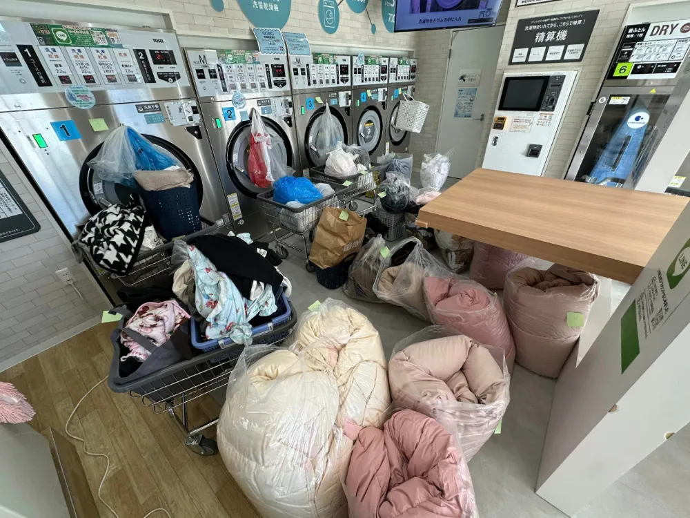 実際に金沢市内で無料提供したコインランドリー。洗濯乾燥機の台数に限りがあるため、順番に使用してもらうほど需要が高かった（右）